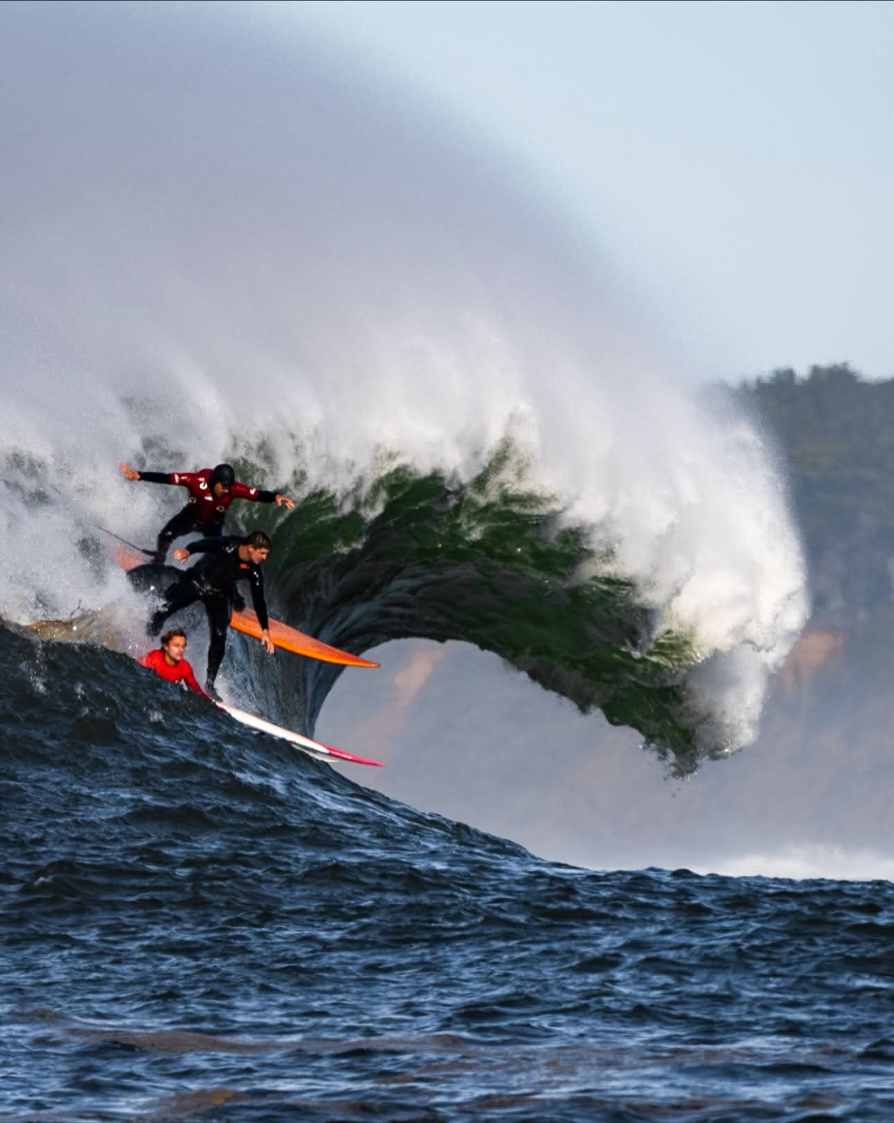 Surfers dropping in on a massive wave at mavericks in half moon bay, California!🌊