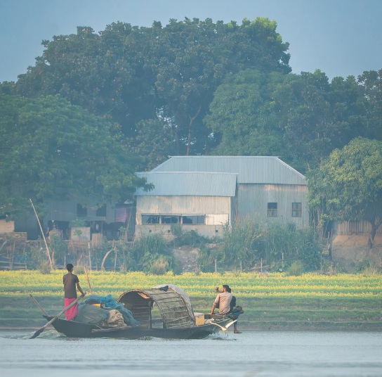 নৌকার হাল ধরে এগিয়ে চলে গ্রামের জীবন।