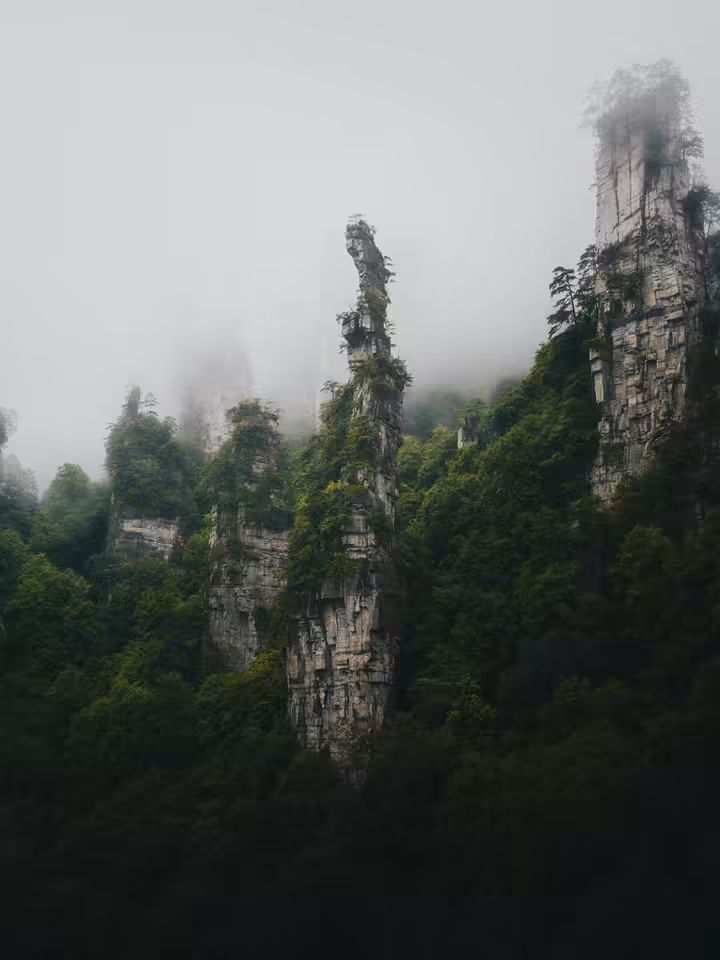 Needle-thin rock towers rising into the mist in China 🇨🇳